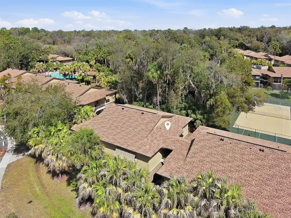 an aerial view of a house with a yard