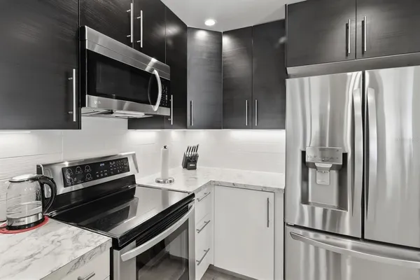 a kitchen with a refrigerator stove and microwave