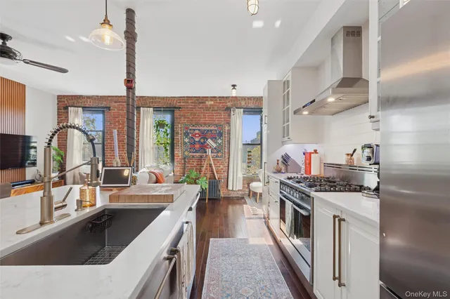 a kitchen with stainless steel appliances granite countertop a sink stove and refrigerator