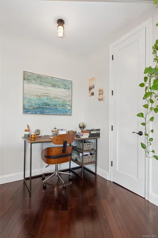 a view of a workspace with furniture and wooden floor