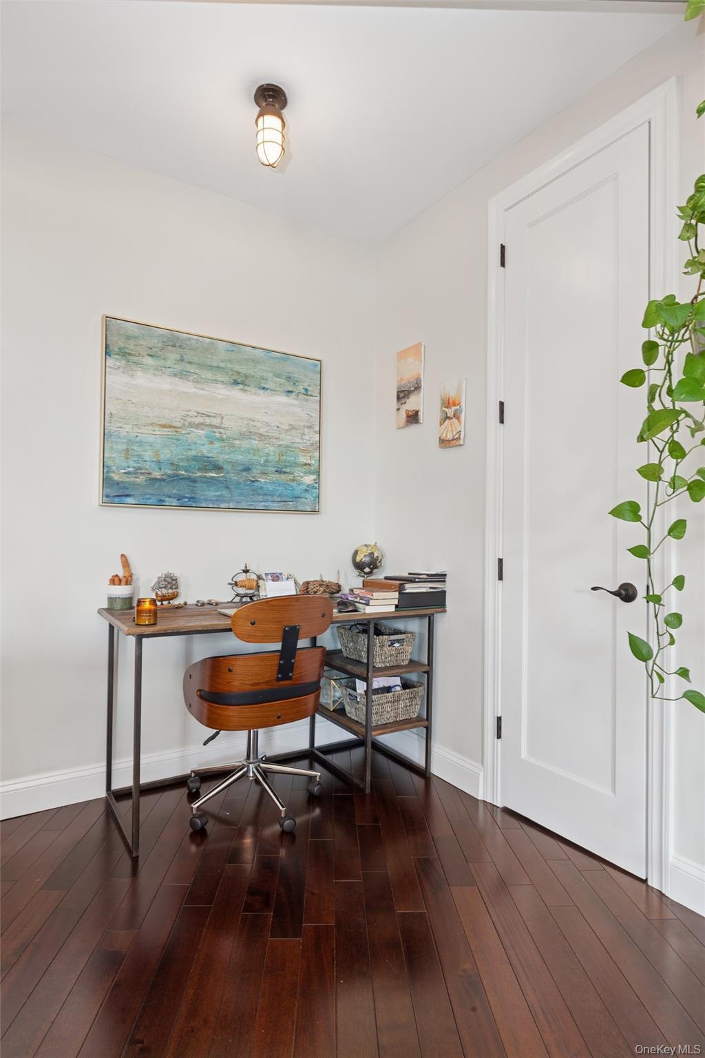 83-74 Talbot Street, Unit 6F Queens, NY 11415 - Photo 5 of 13 a view of a workspace with furniture and wooden floor