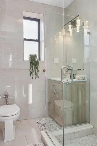 a bathroom with a shower a mirror and a toilet
