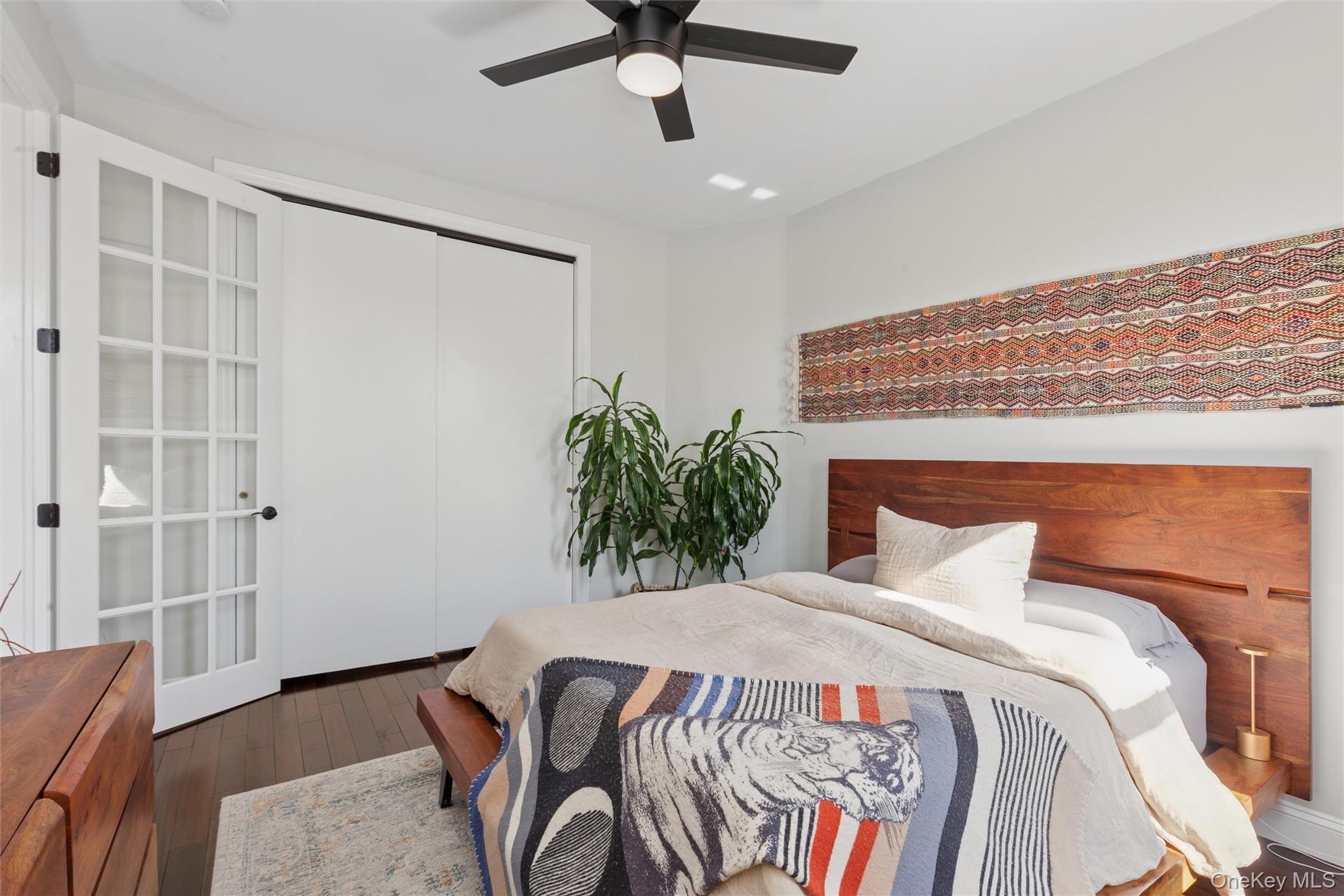 83-74 Talbot Street, Unit 6F Queens, NY 11415 - Photo 8 of 13 a bedroom with a bed and a chandelier