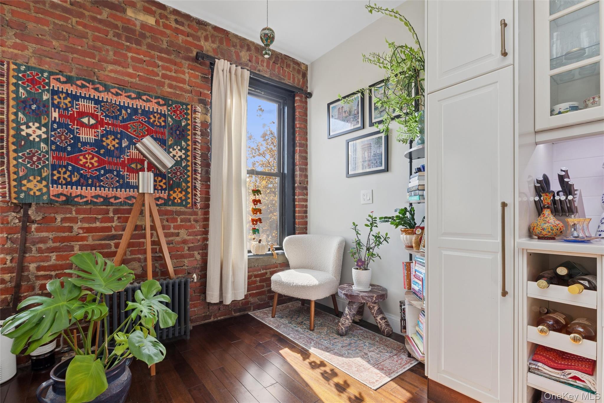 83-74 Talbot Street, Unit 6F Queens, NY 11415 - Photo 10 of 13 a living room with furniture and a potted plant