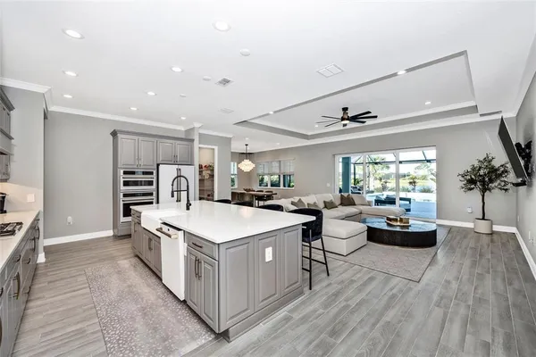 a kitchen with white cabinets a sink and dishwasher