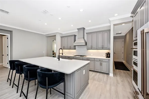 a view of kitchen with wooden floor and electronic appliances