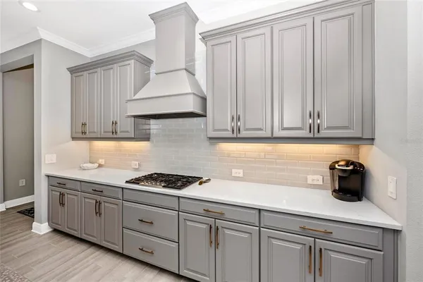 a living room with furniture a large window and a chandelier
