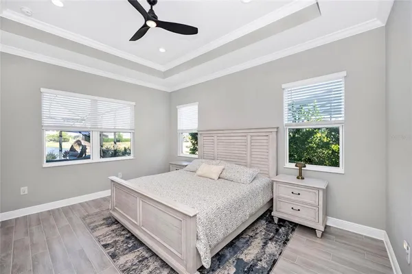 a bedroom with a bed and a large window