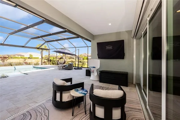 a view of a house with a yard and palm trees