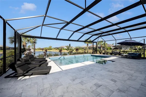 a view of a swimming pool with an ocean and trees
