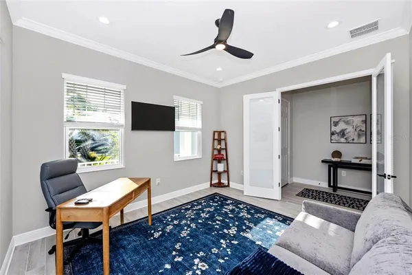 a open kitchen with stainless steel appliances granite countertop a stove top oven a sink a dining table and chairs with wooden floor