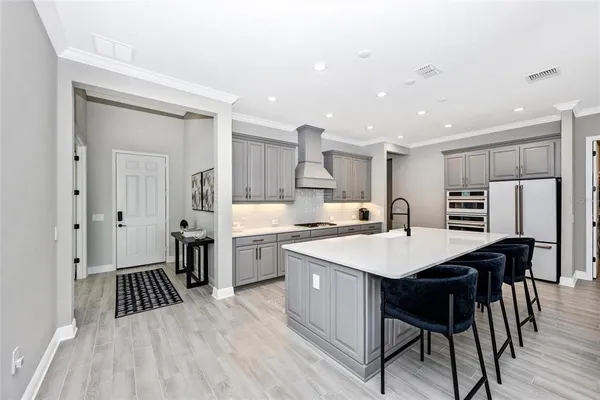 a large kitchen with a table and chairs