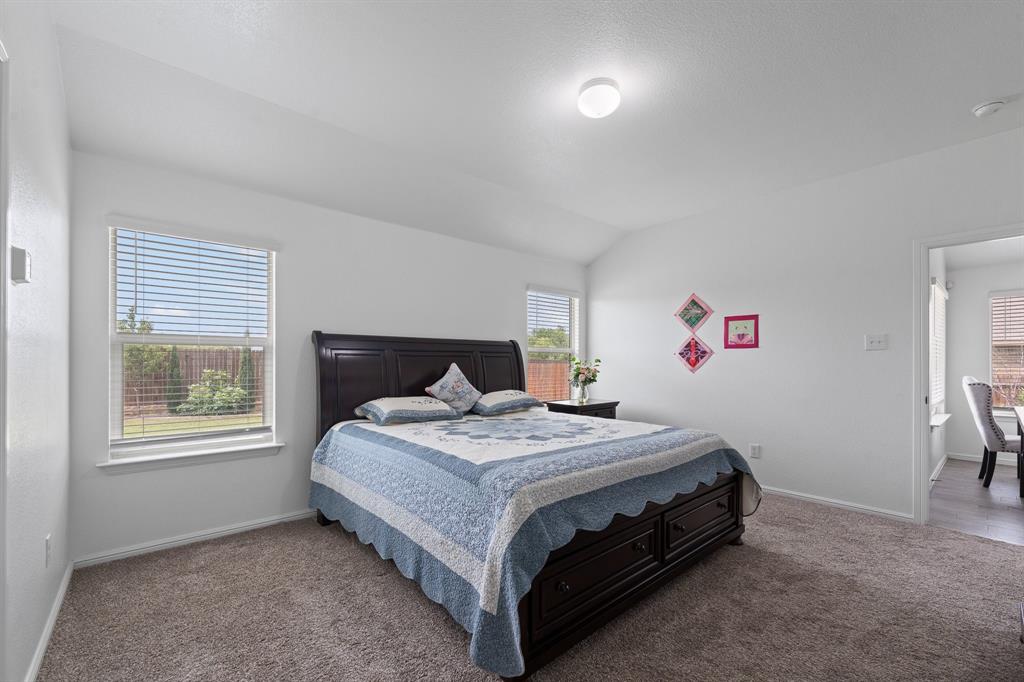 4600 Fringetree Way Crowley, TX 76036 - Photo 20 of 40 Carpeted room with vaulted ceiling and two windows