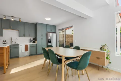 a large kitchen with a table and chairs