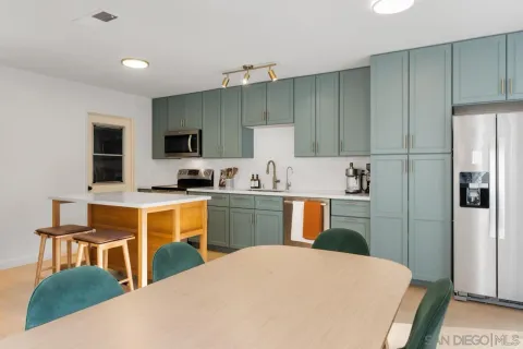 a kitchen with a stove a sink and a refrigerator