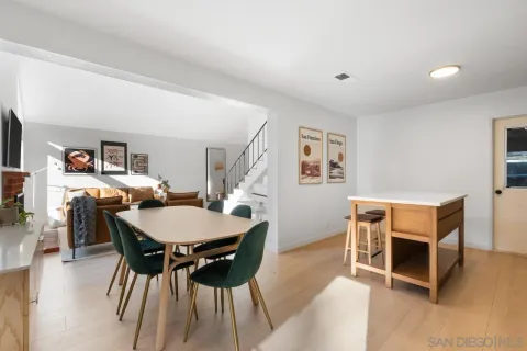 a kitchen with kitchen island a counter top space a sink stainless steel appliances and cabinets