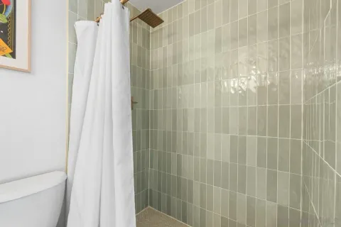 a bedroom with a bed and a mirror