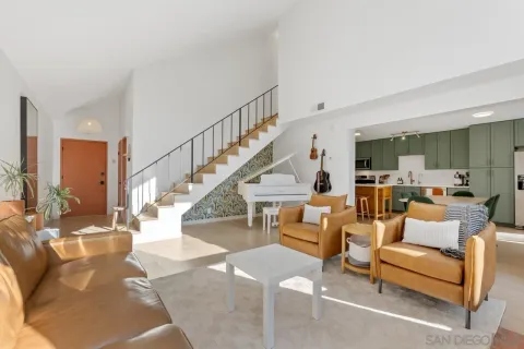 a living room with furniture or couches and a dining table with wooden floor