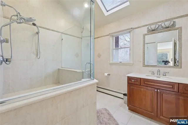 a bathroom with a granite countertop a toilet and a shower