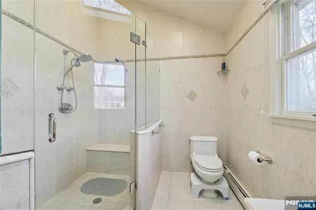 a spacious bedroom with a bed and a window