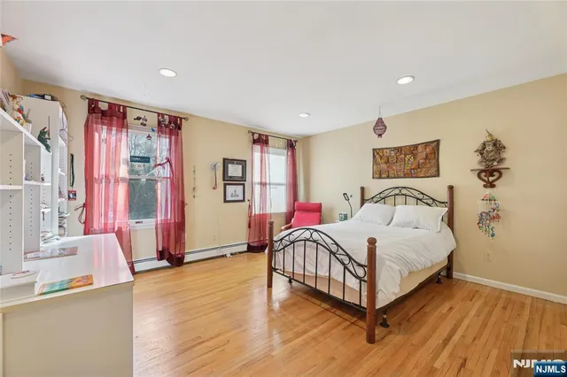 a bedroom with furniture and wooden floor