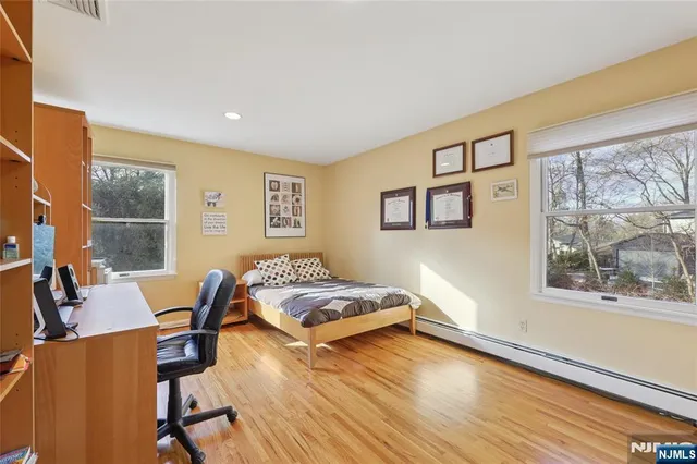 a living room with a bed furniture and a window