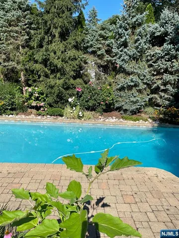 a view of backyard of house with outdoor seating
