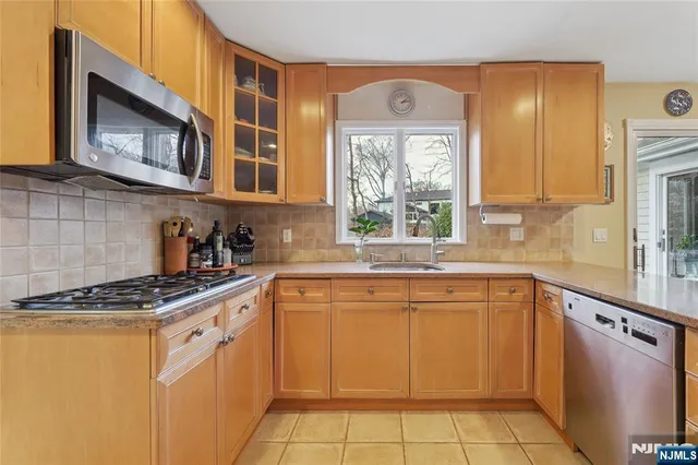 a kitchen with a table chairs refrigerator and cabinets