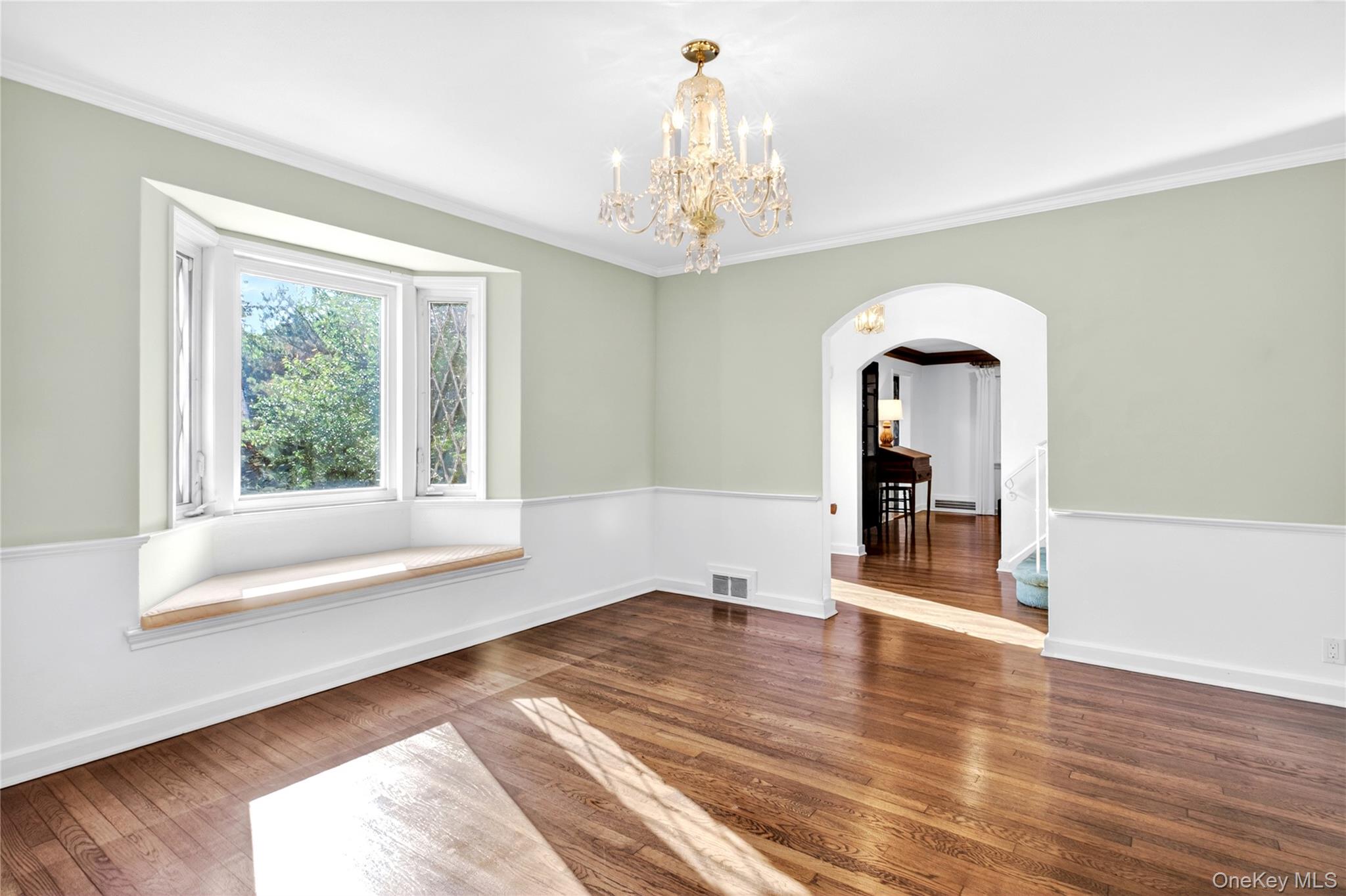 142 Mill Spring Road Manhasset, NY 11030 - Photo 8 of 23 a view of an empty room with wooden floor and a window