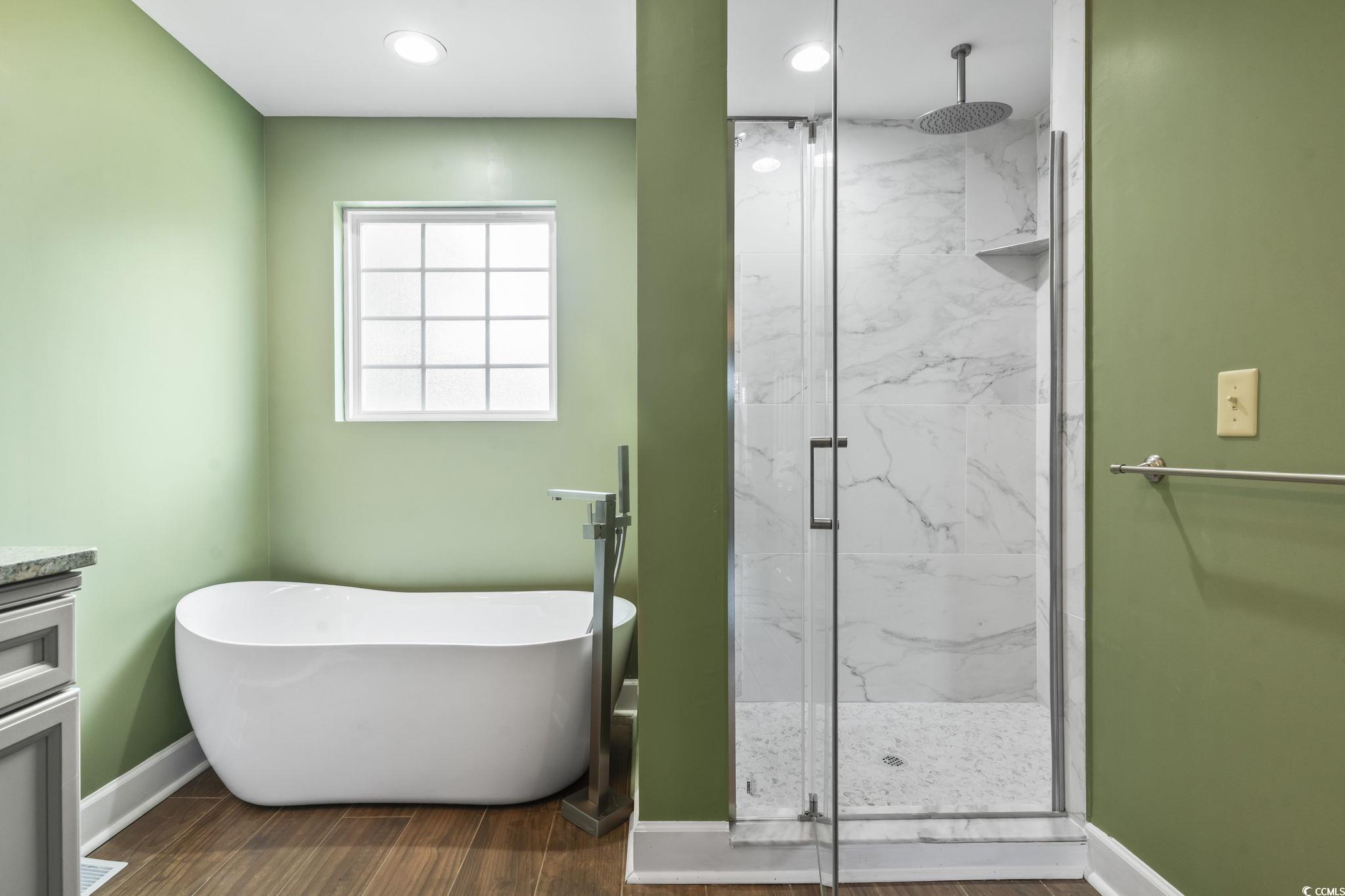 1585 Daisy Road Loris, SC 29569 - Photo 18 of 48 Bathroom with a marble finish shower, vanity, a soaking tub, and dark wood finished floors