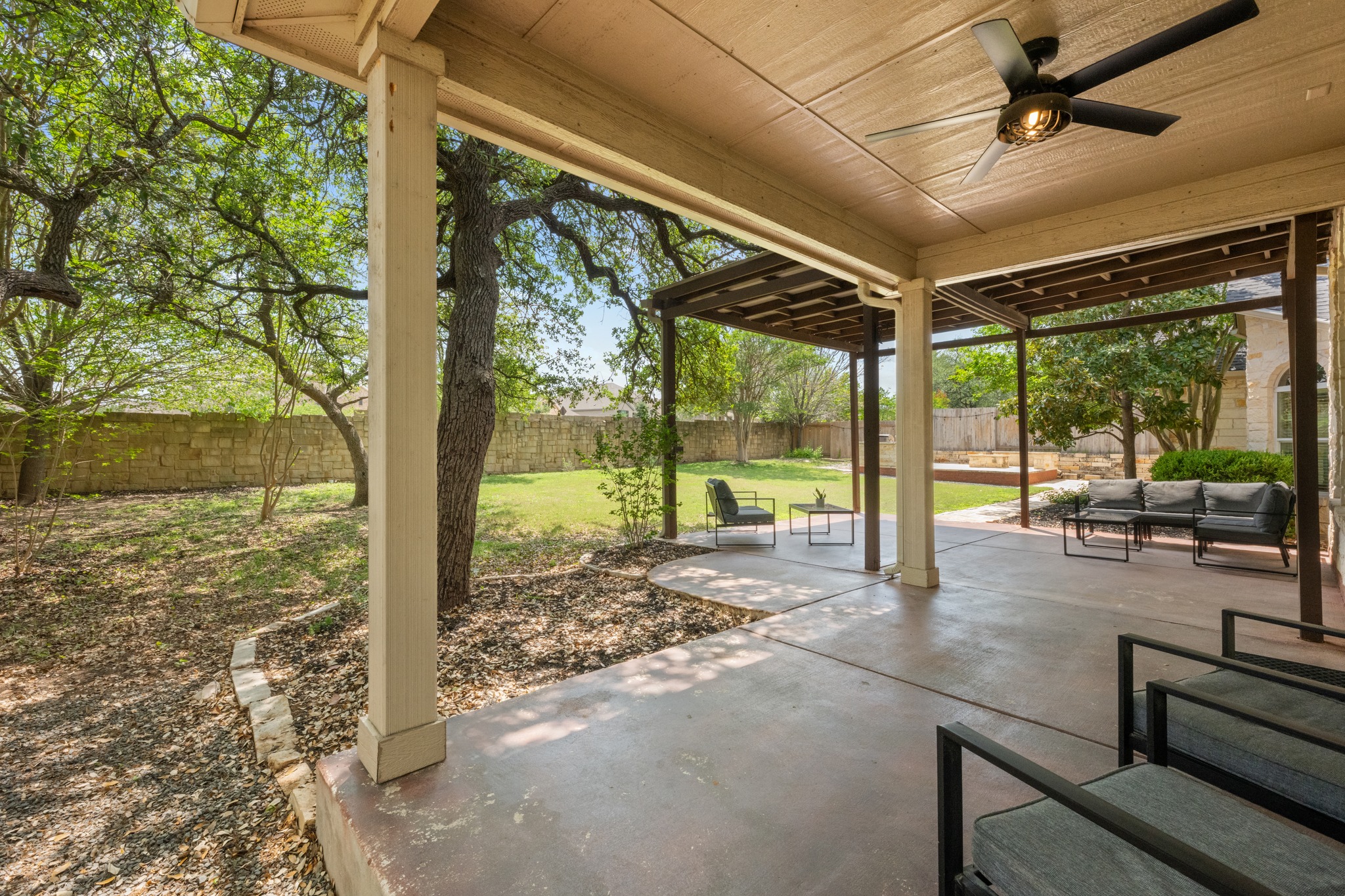 1023 Grassy Field Road Austin, TX 78737 - Photo 32 of 40 Expansive covered patio with concrete flooring and a built-in ceiling fan