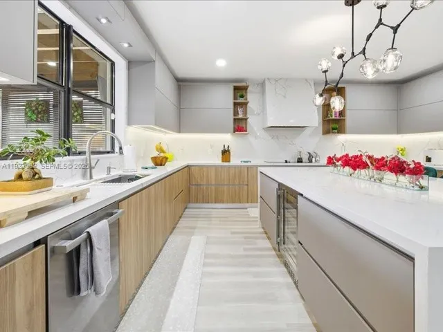 a bathroom with a sink and large mirror