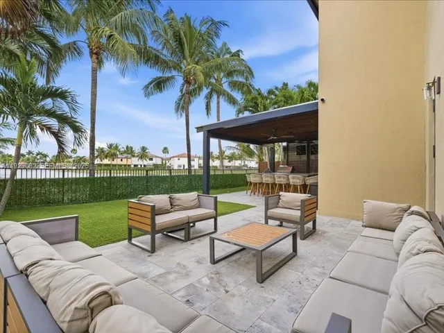 a view of a patio with couches and a big yard