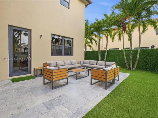 a backyard of a house with outdoor seating