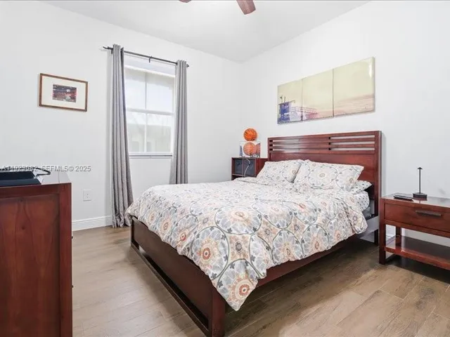 a bedroom with bed and window