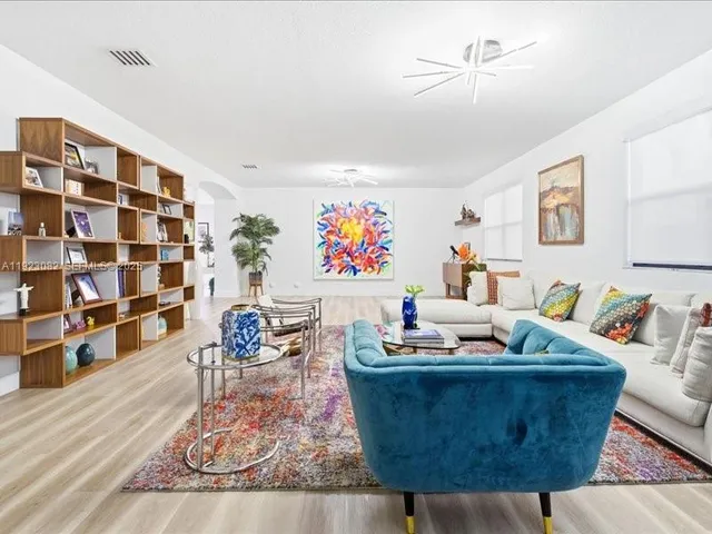 a living room with furniture and wooden floor