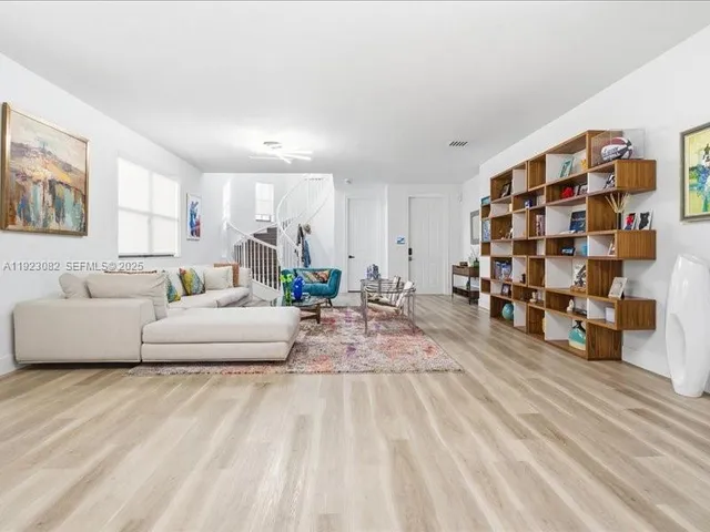 a living room with furniture and natural light