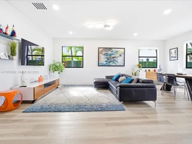 a living room with furniture window and flat screen tv