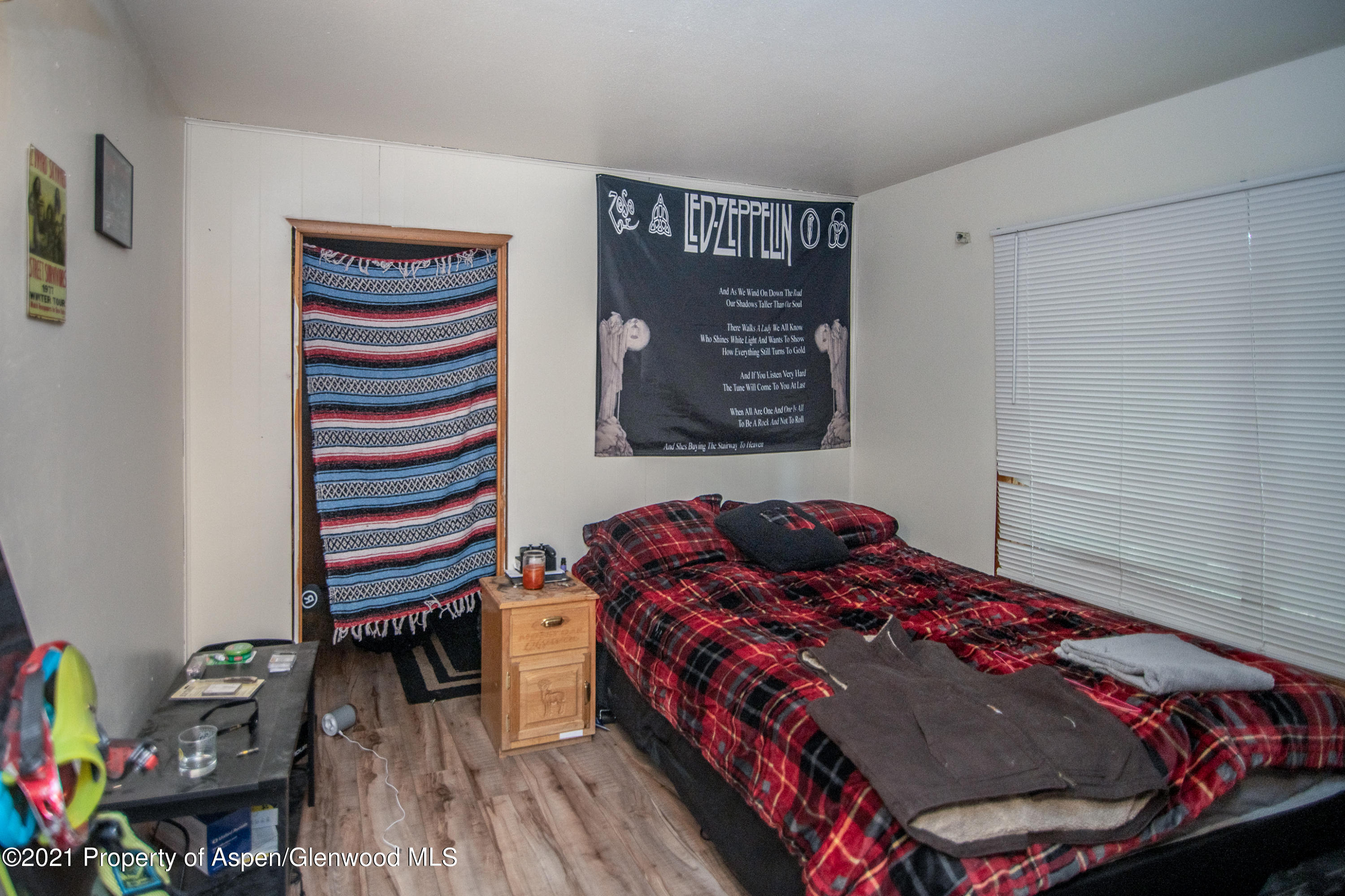 761 Rose Street Craig, CO 81625 - Photo 14 of 42 a bedroom with a bed and a book shelf