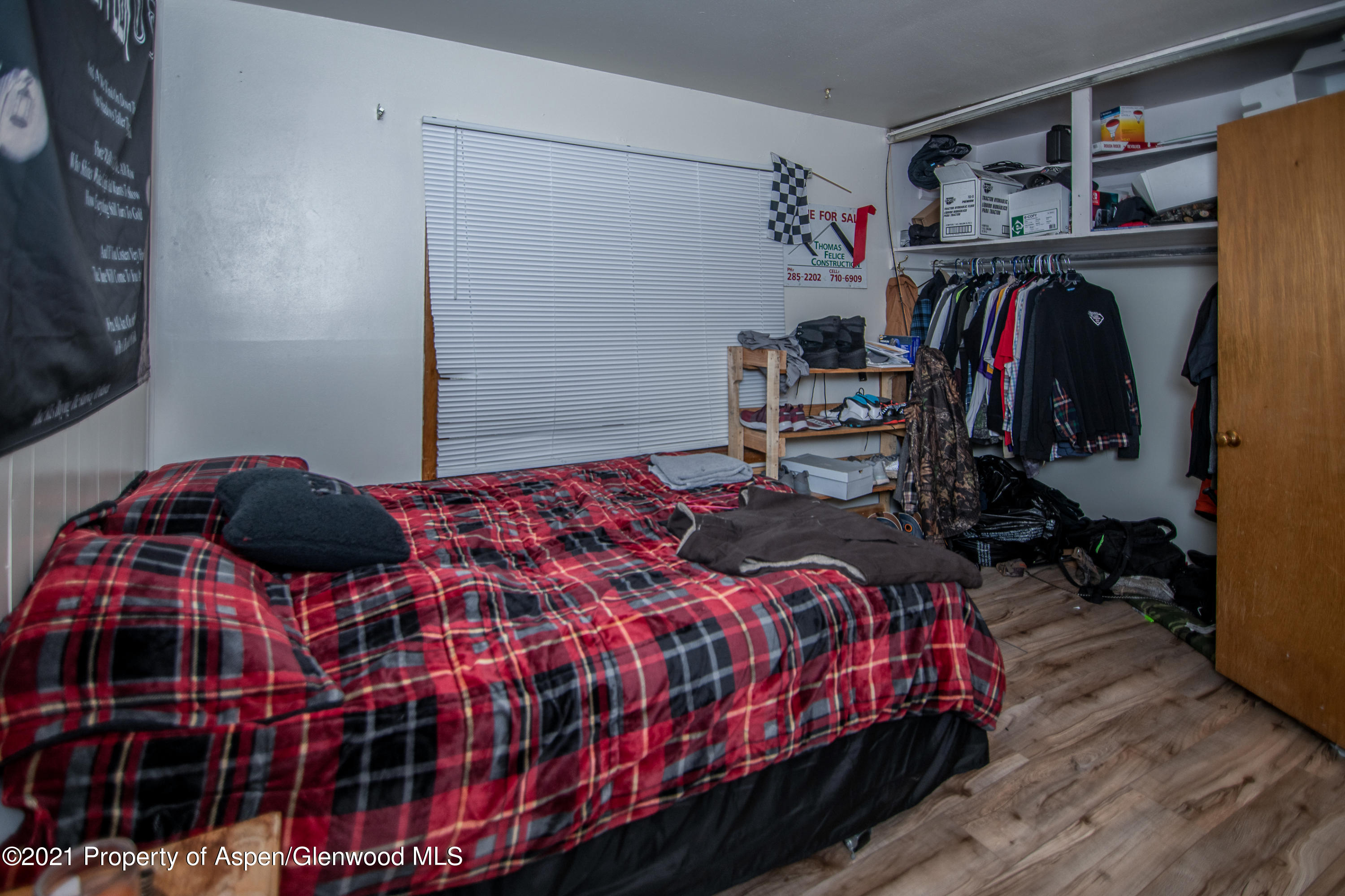 761 Rose Street Craig, CO 81625 - Photo 15 of 42 a bedroom with a bed and walk in closet