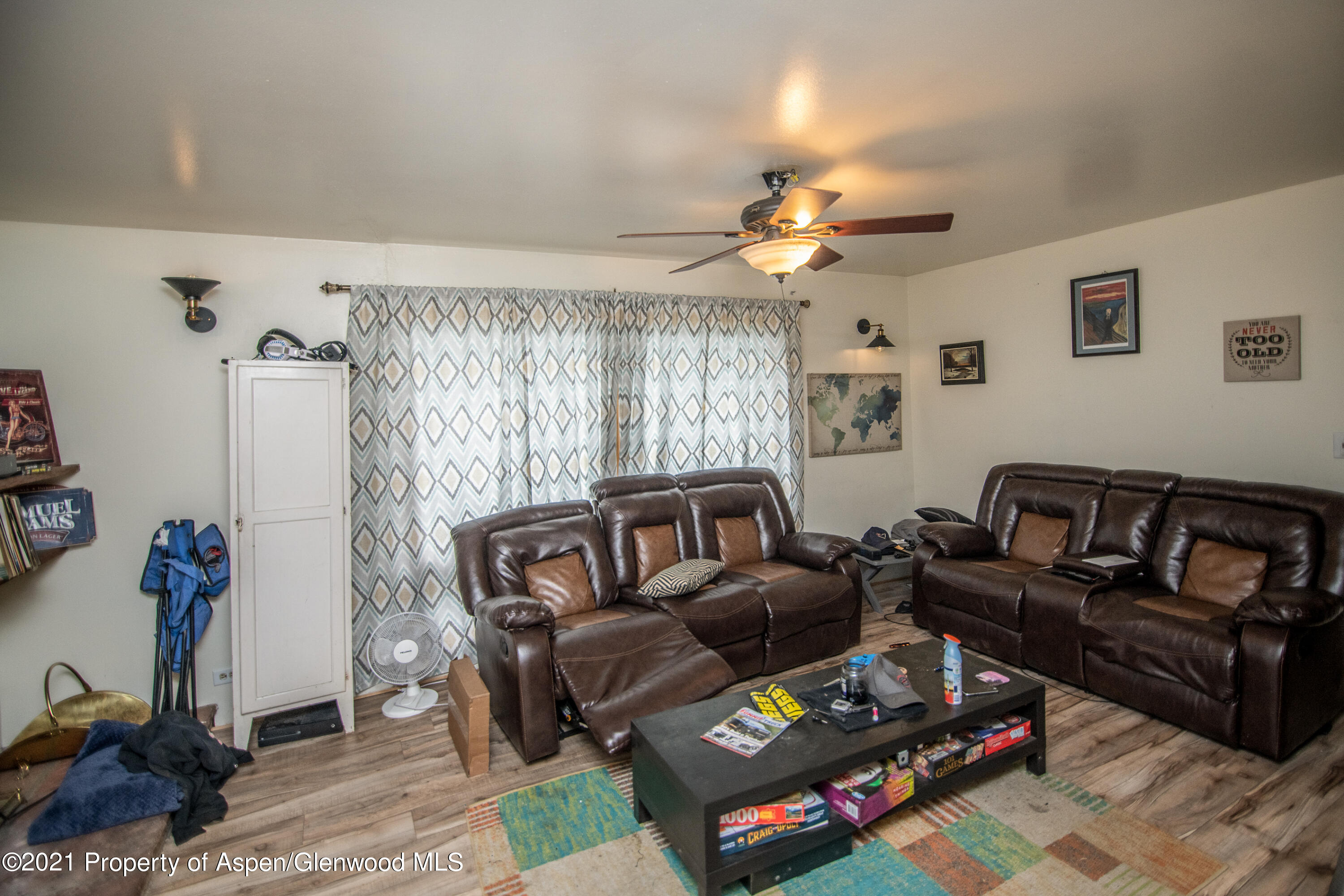 761 Rose Street Craig, CO 81625 - Photo 17 of 42 a living room with furniture a rug and a chandelier