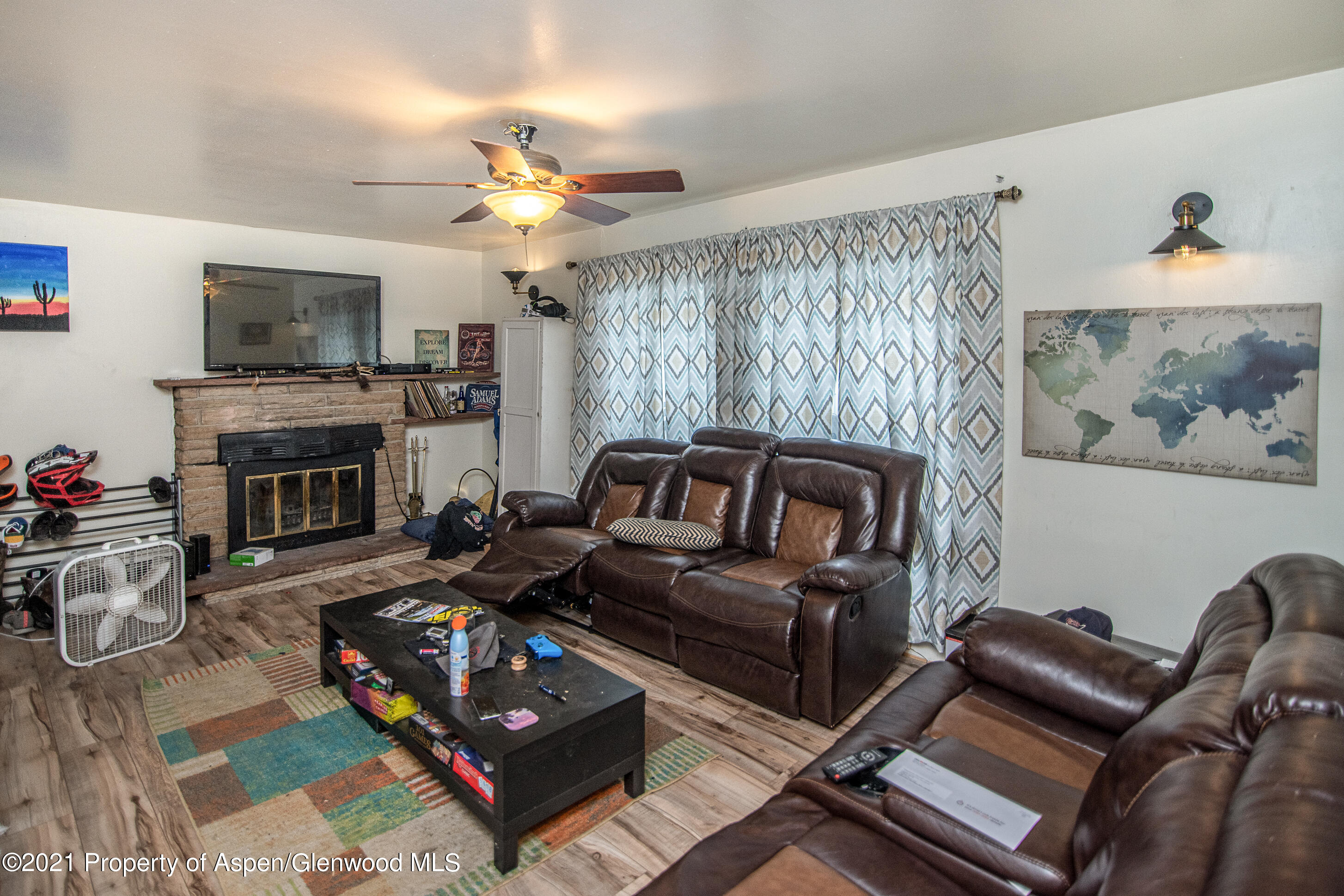 761 Rose Street Craig, CO 81625 - Photo 18 of 42 a living room with furniture a flat screen tv and a fireplace