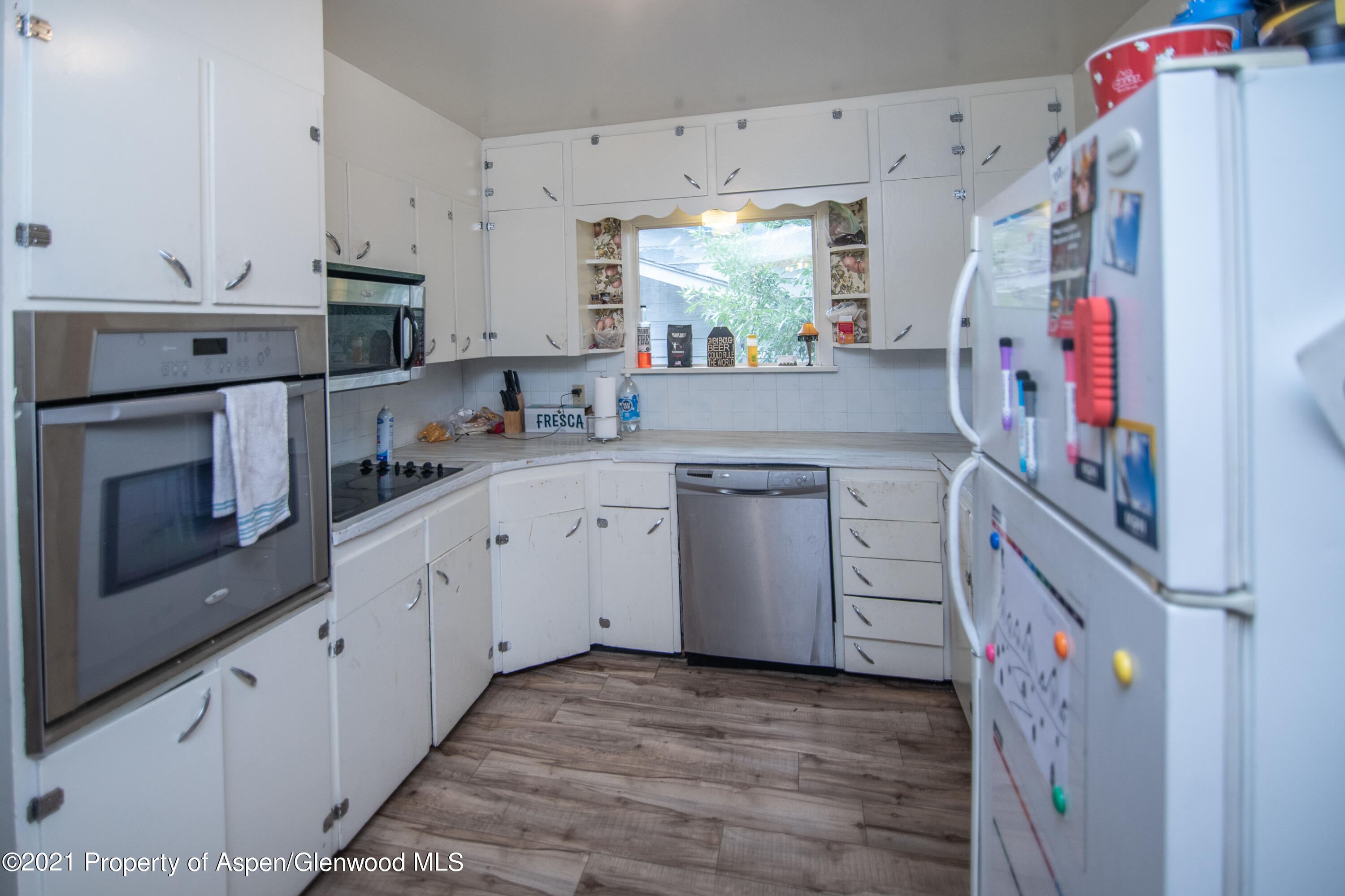761 Rose Street Craig, CO 81625 - Photo 26 of 42 a kitchen with cabinets and white appliances