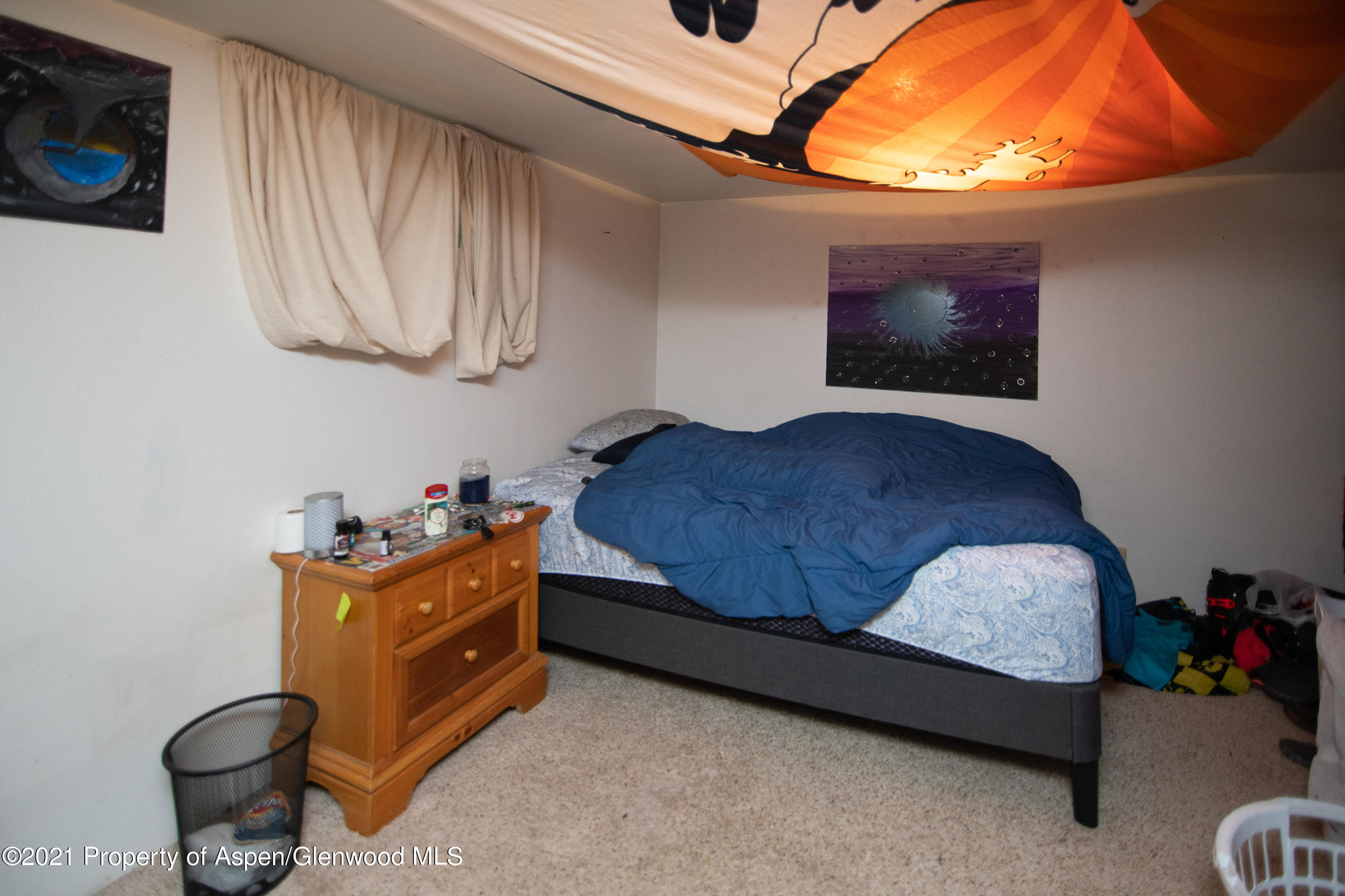 761 Rose Street Craig, CO 81625 - Photo 31 of 42 a bedroom with a bed and a chandelier