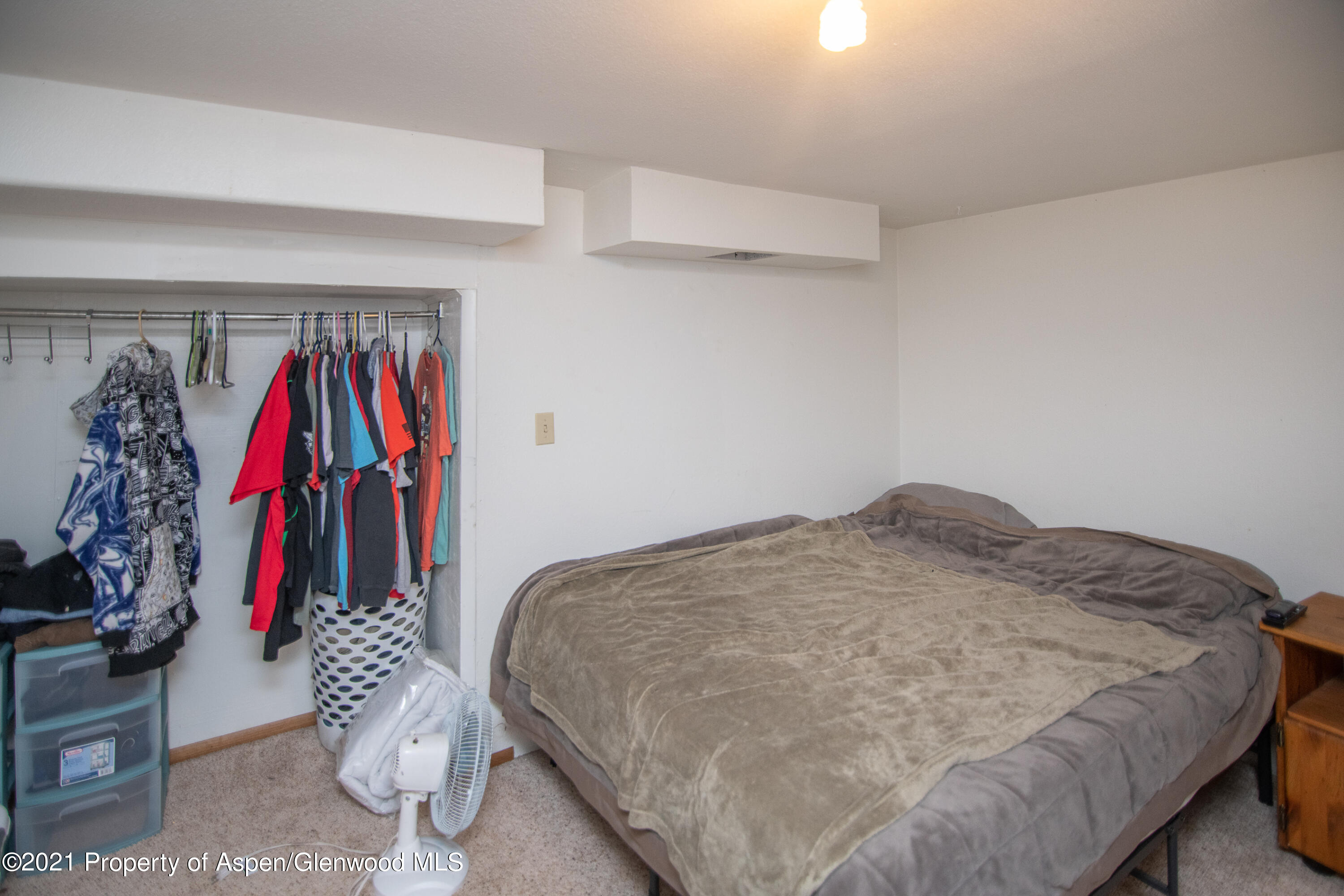 761 Rose Street Craig, CO 81625 - Photo 37 of 42 a bed room with a bed and a walk in closet