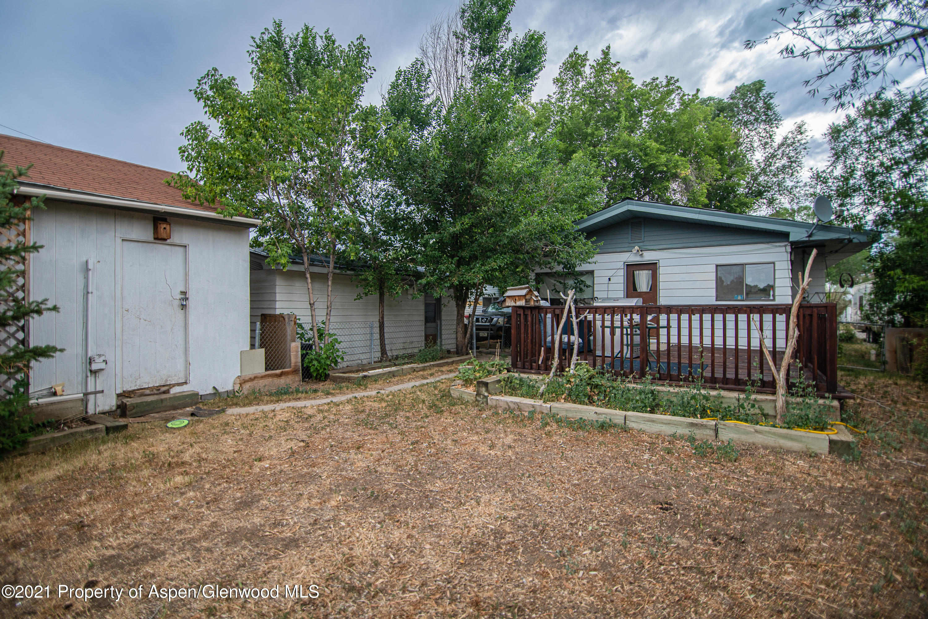 761 Rose Street Craig, CO 81625 - Photo 7 of 42 a view of a house with a yard and fence