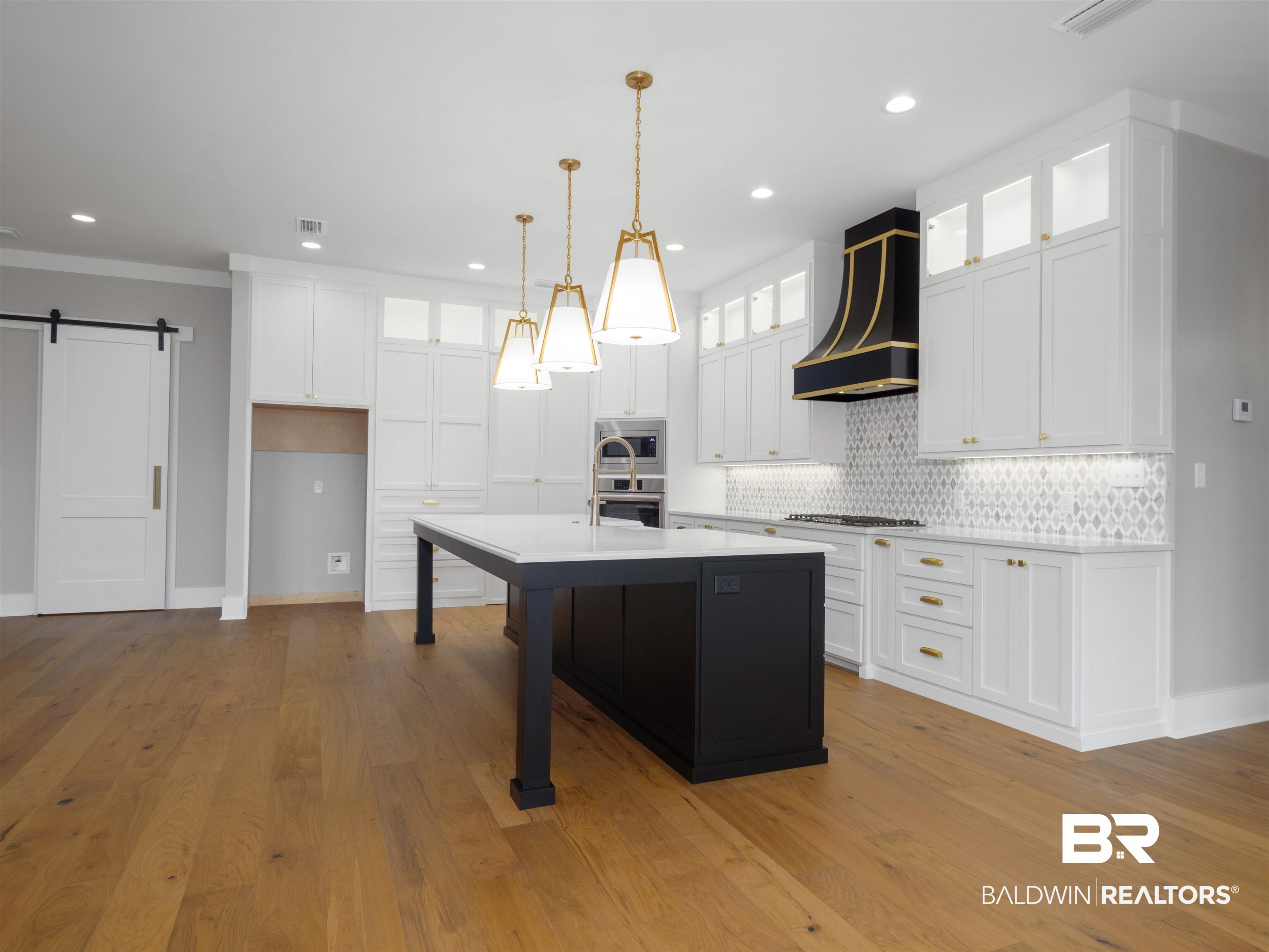10912 Catania Avenue Fairhope, AL 36532 - Photo 12 of 54 Kitchen feature quartz countertops, stainless steel appliances, and Kohler cast iron sink