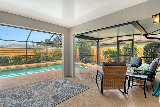 a kitchen with granite countertop a sink and white cabinets
