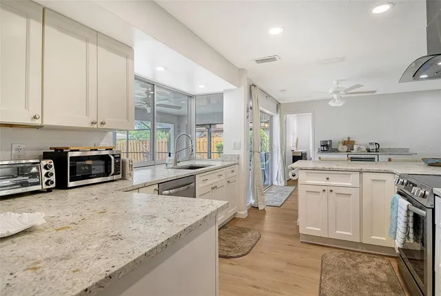 a bedroom with a bed a dresser and next to a window