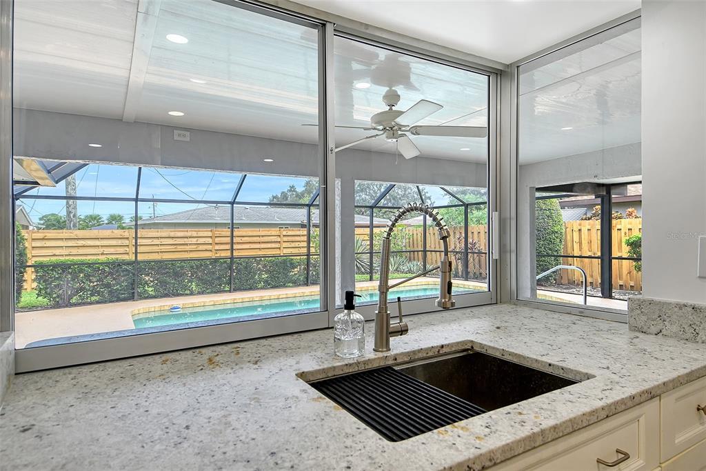 6722 Roxbury Drive Sarasota, FL 34231 - Photo 29 of 87 a kitchen with a sink and large window